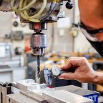 mechanical engineer checking tools and measurements in a manufacturing facility