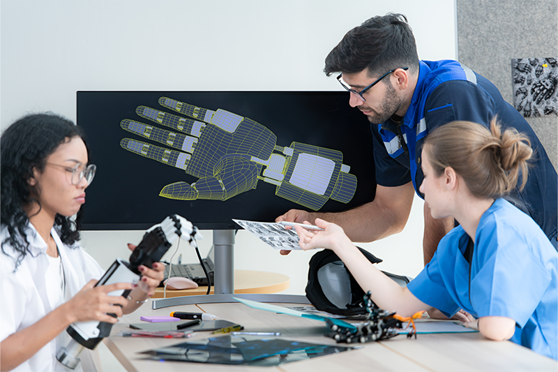 team testing a robotic arm in manufacturing